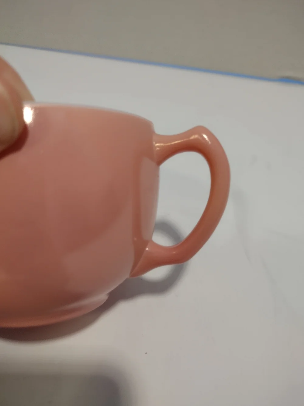Vintage pink glass creamer by Hazel-Atlas with a C-shaped handle and spout